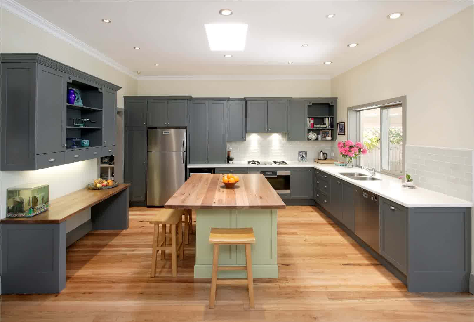 A Kitchen With Grey Cabinets And Wooden Floors Wallpaper
