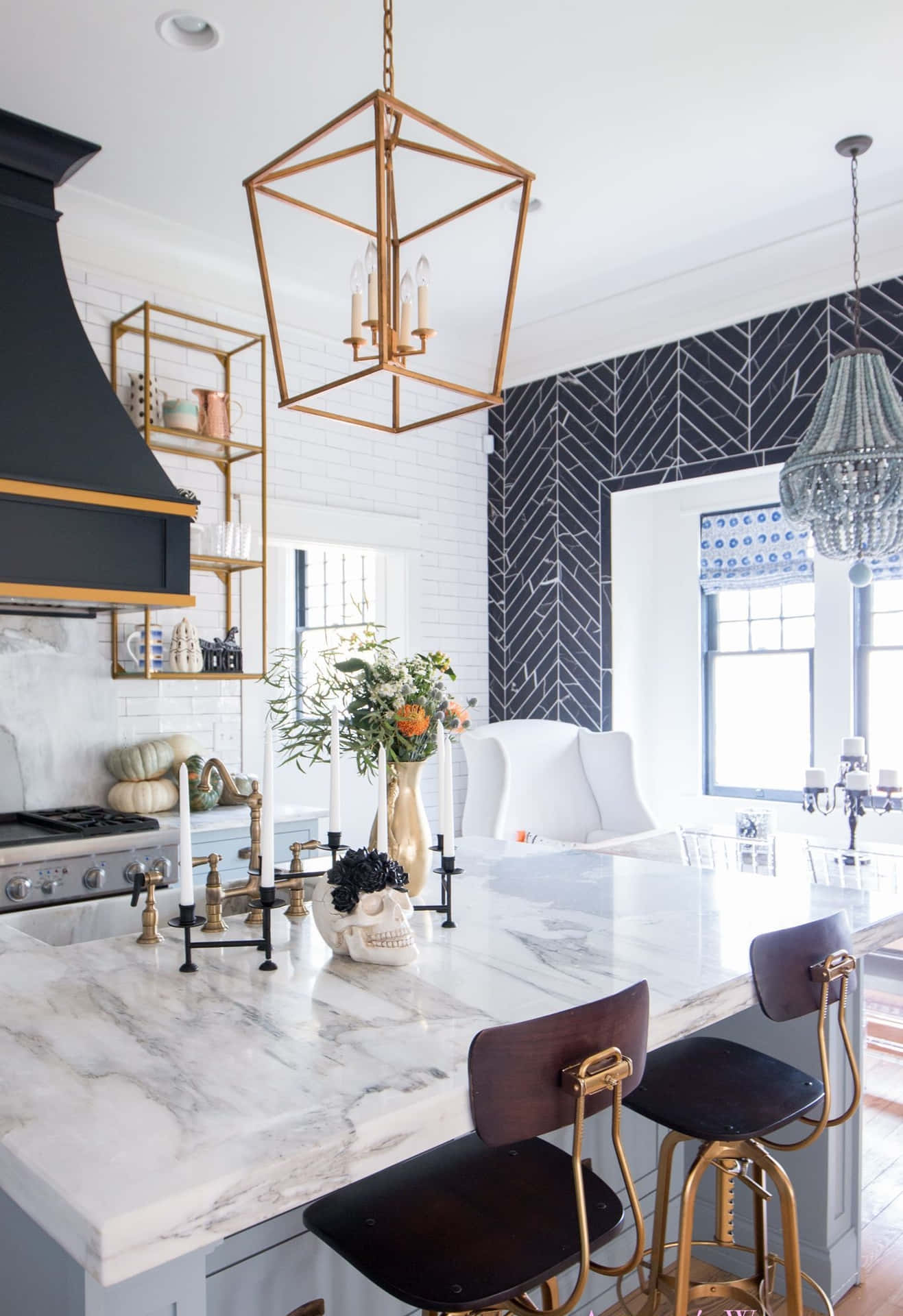 A Kitchen With A Marble Counter Top And Gold Stools Wallpaper