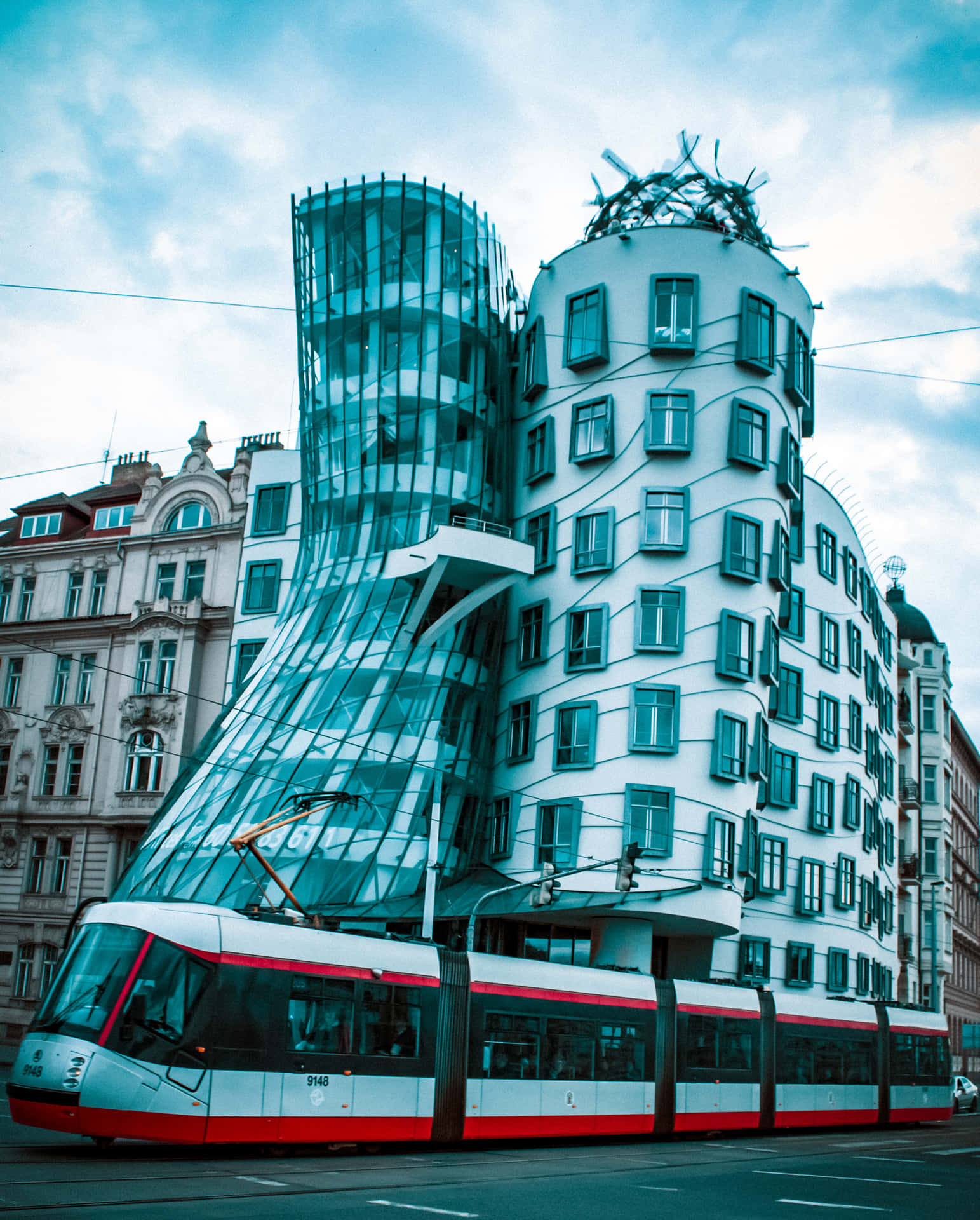 Modern Train Passing By Dancing House Wallpaper