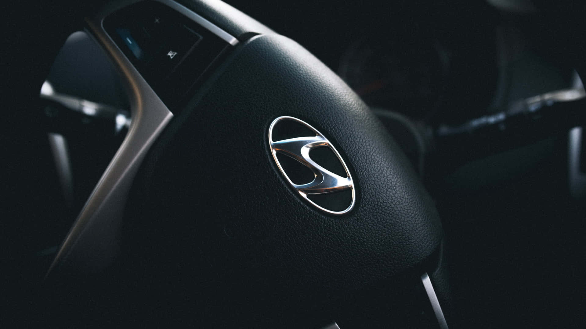 Modern Vehicle Steering Wheel Logo Wallpaper