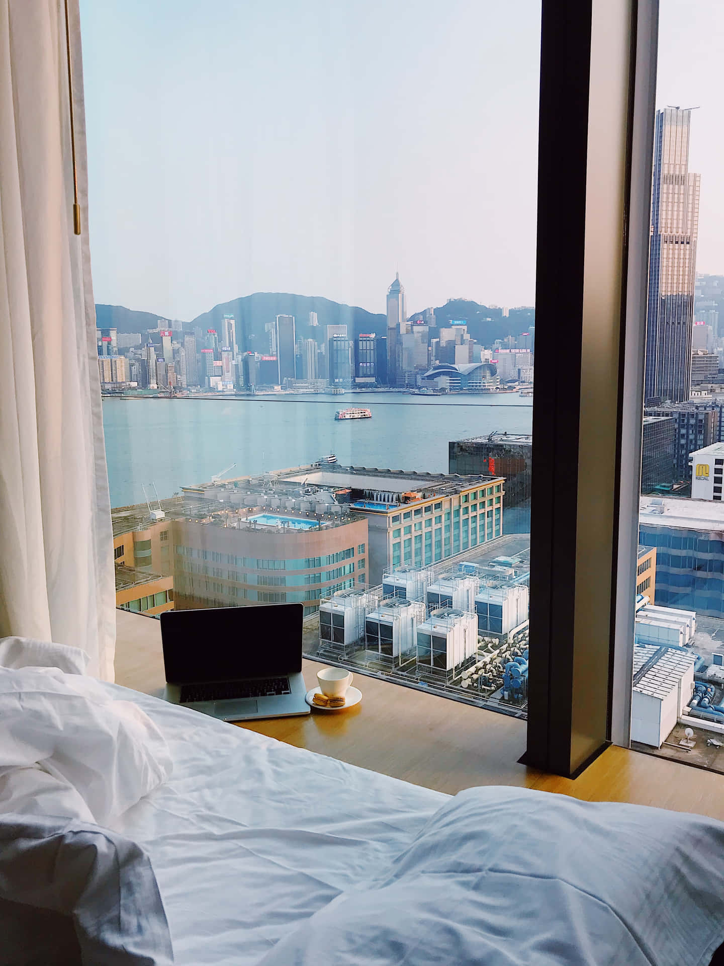 Luxurious Hotel Room Overlooking Urban Skyline Wallpaper