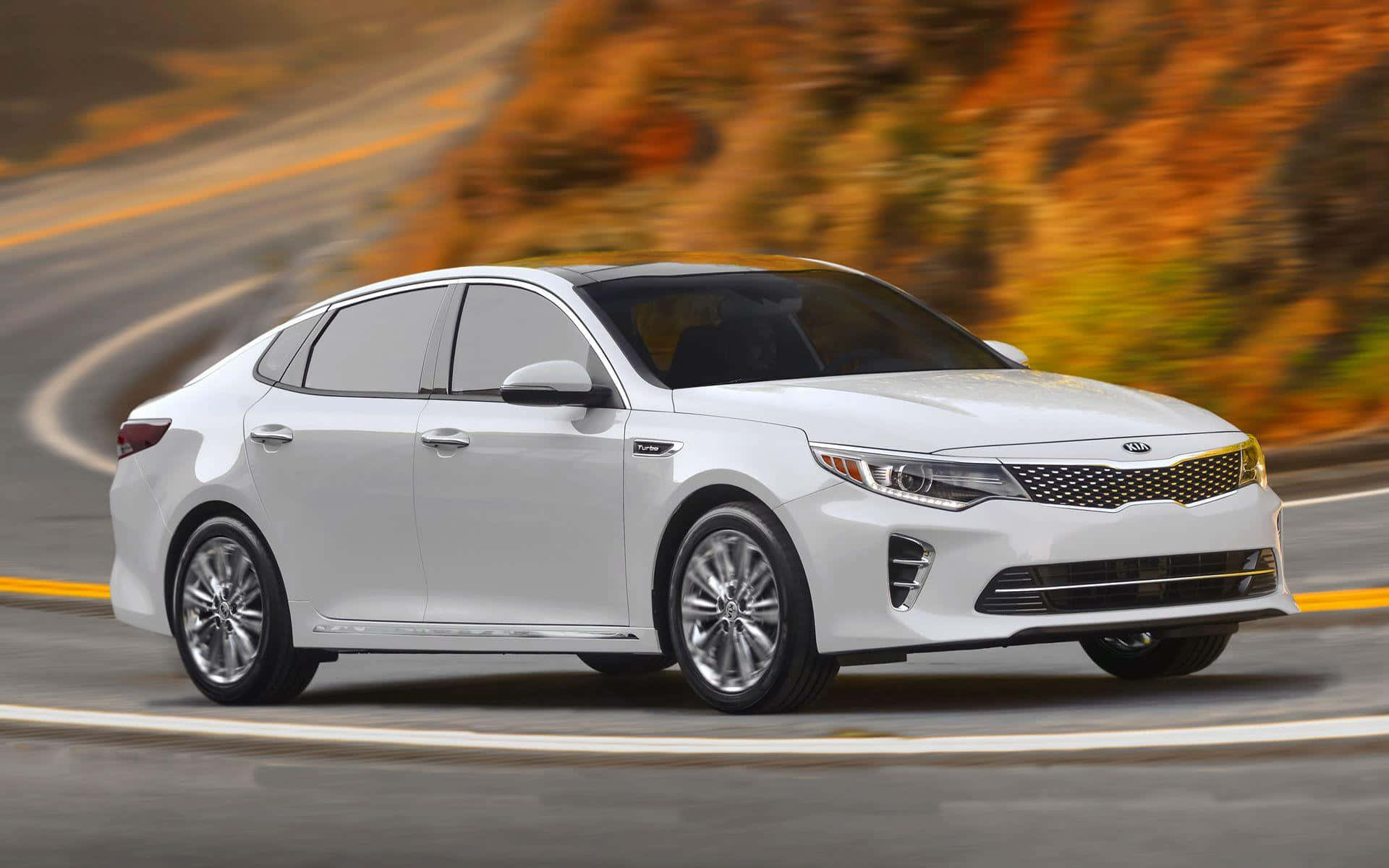 Modernday Elegance - Kia Optima In Scenic Sunset Wallpaper