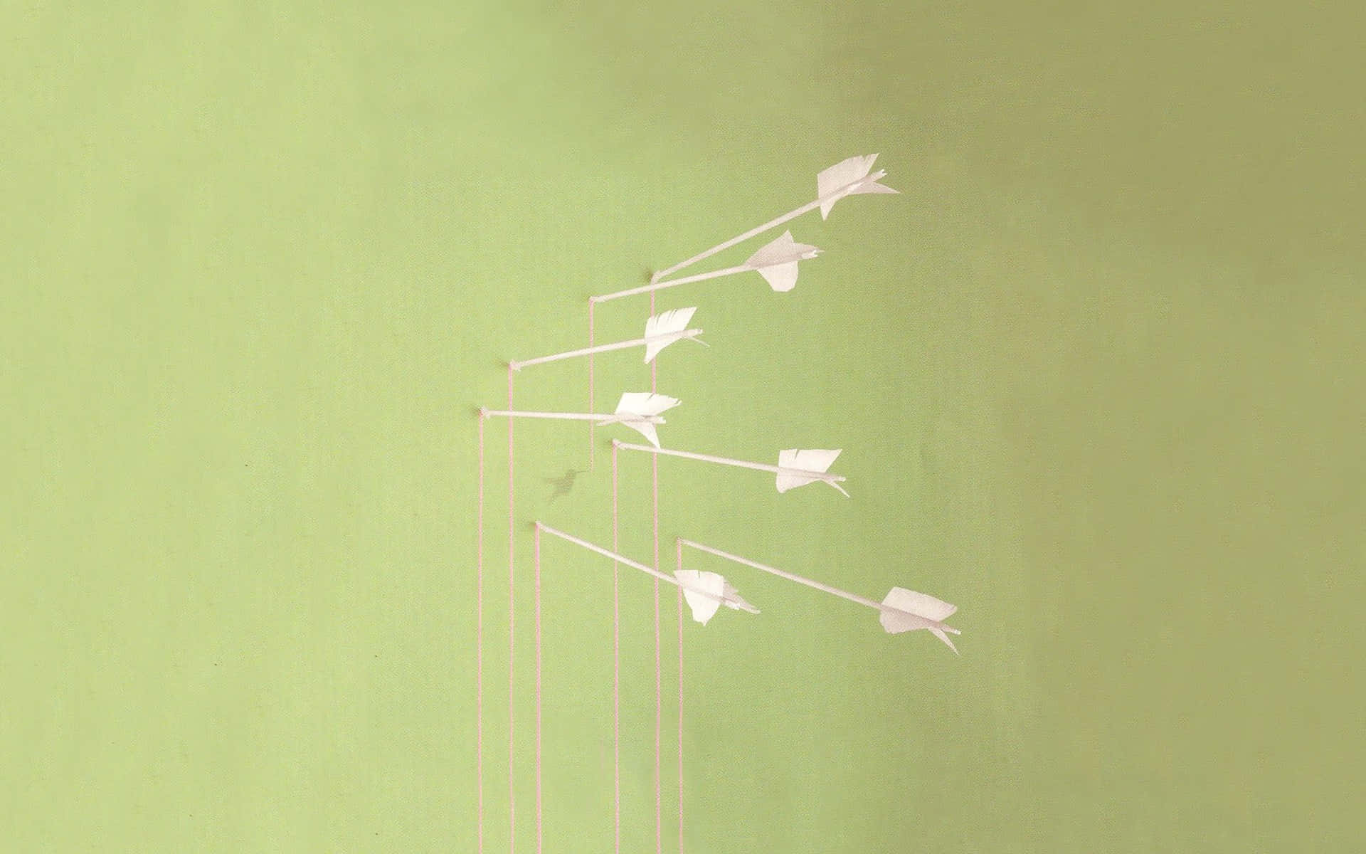 Ungrupo De Pájaros De Papel En Una Pared Verde Fondo de pantalla