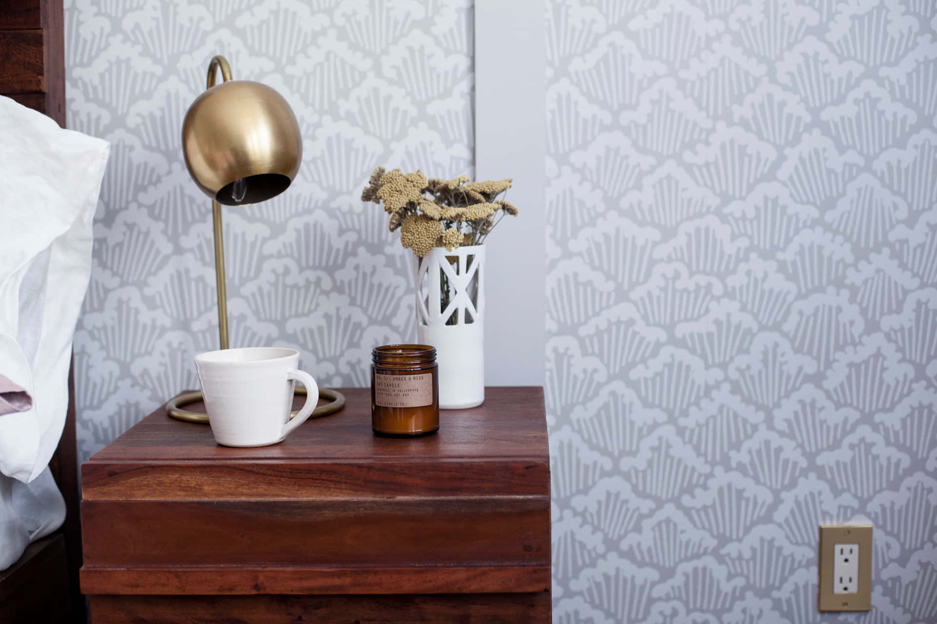 A Bedside Table With A Lamp And A Cup Of Coffee Wallpaper
