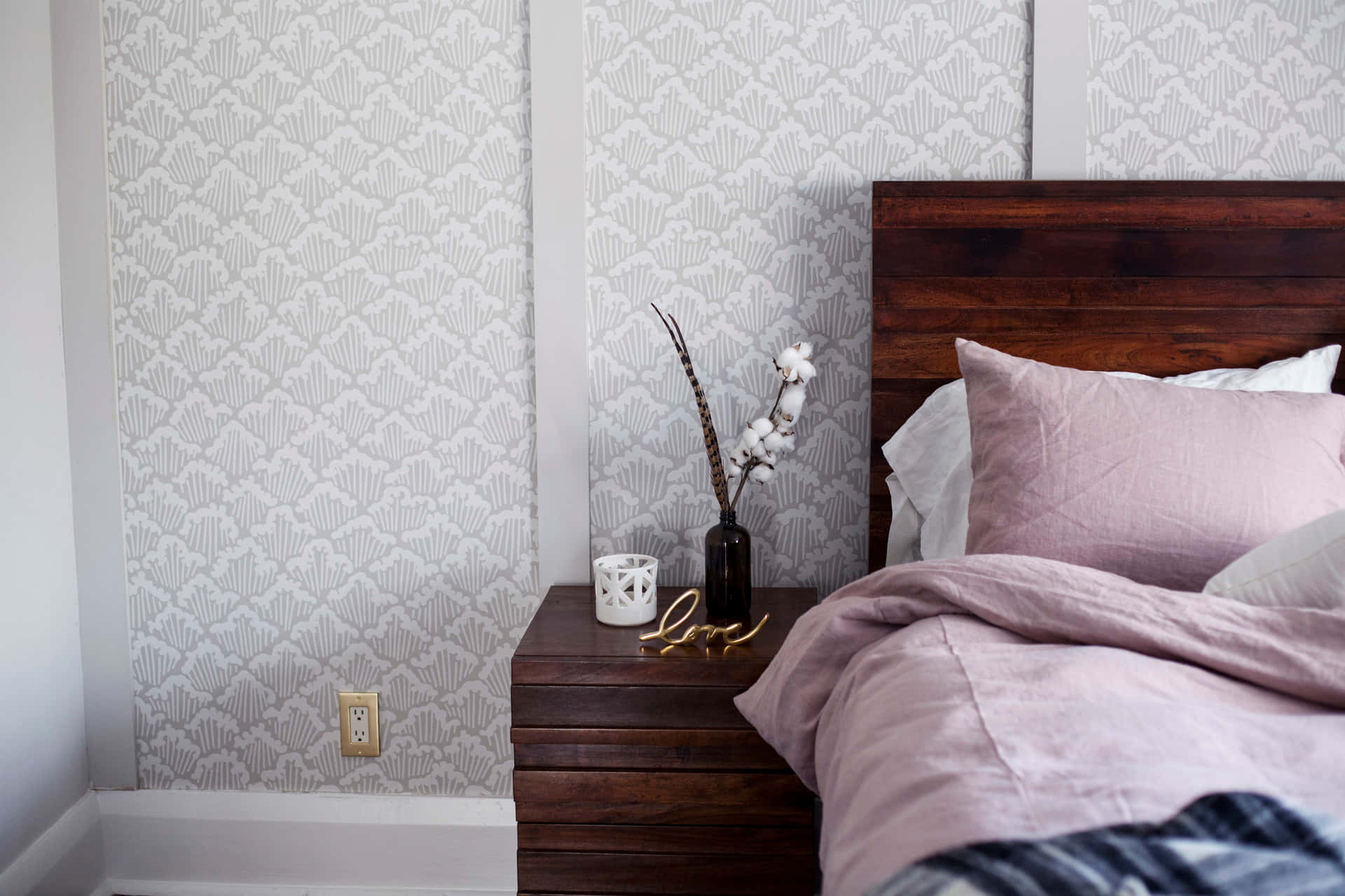 A Bedroom With A Pink Comforter And A Wooden Bed Wallpaper