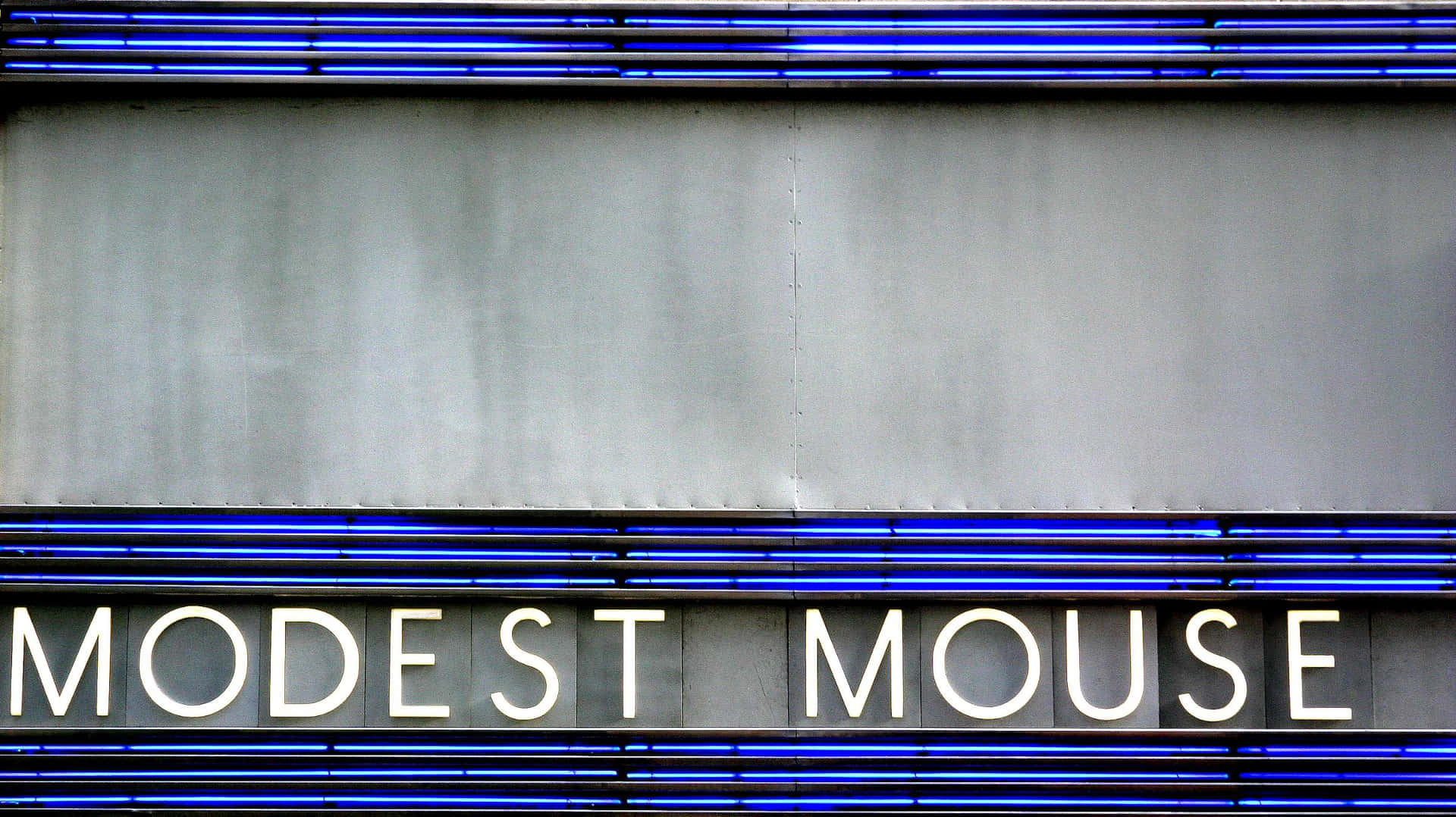 Modest Mouse Signage Mounted On The Wall Wallpaper