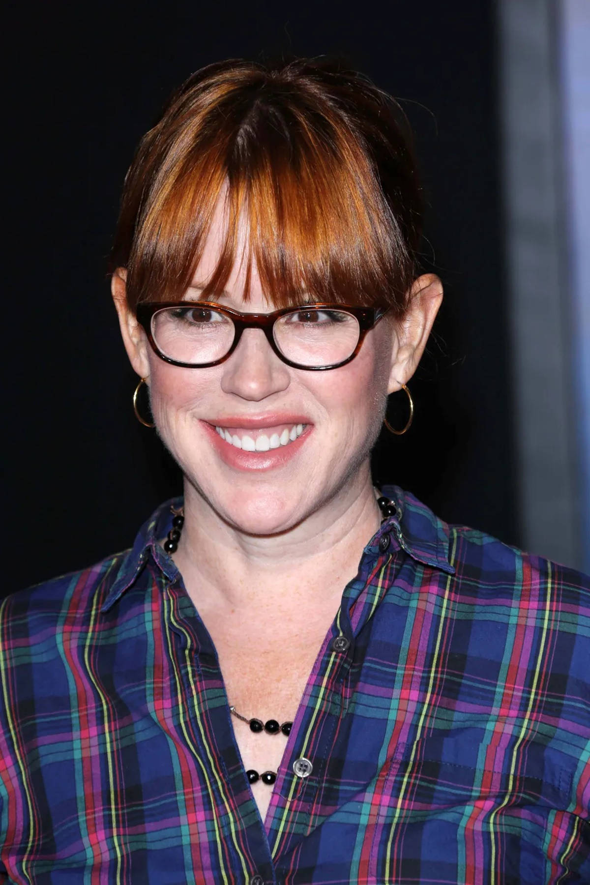 Molly Ringwald Wearing Nerdy Glasses On Background