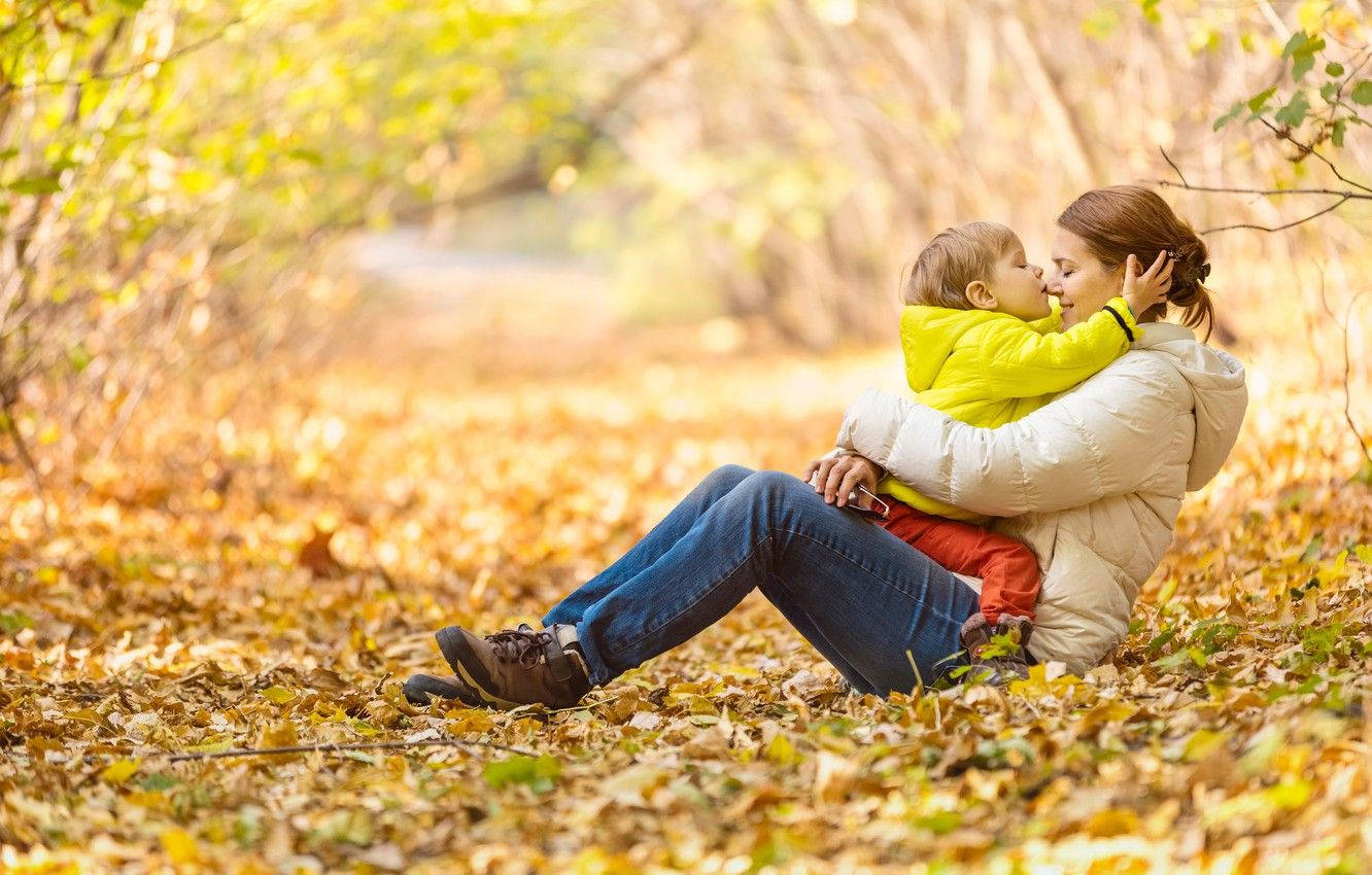 Mom and Son Playing in Autumn Wallpaper