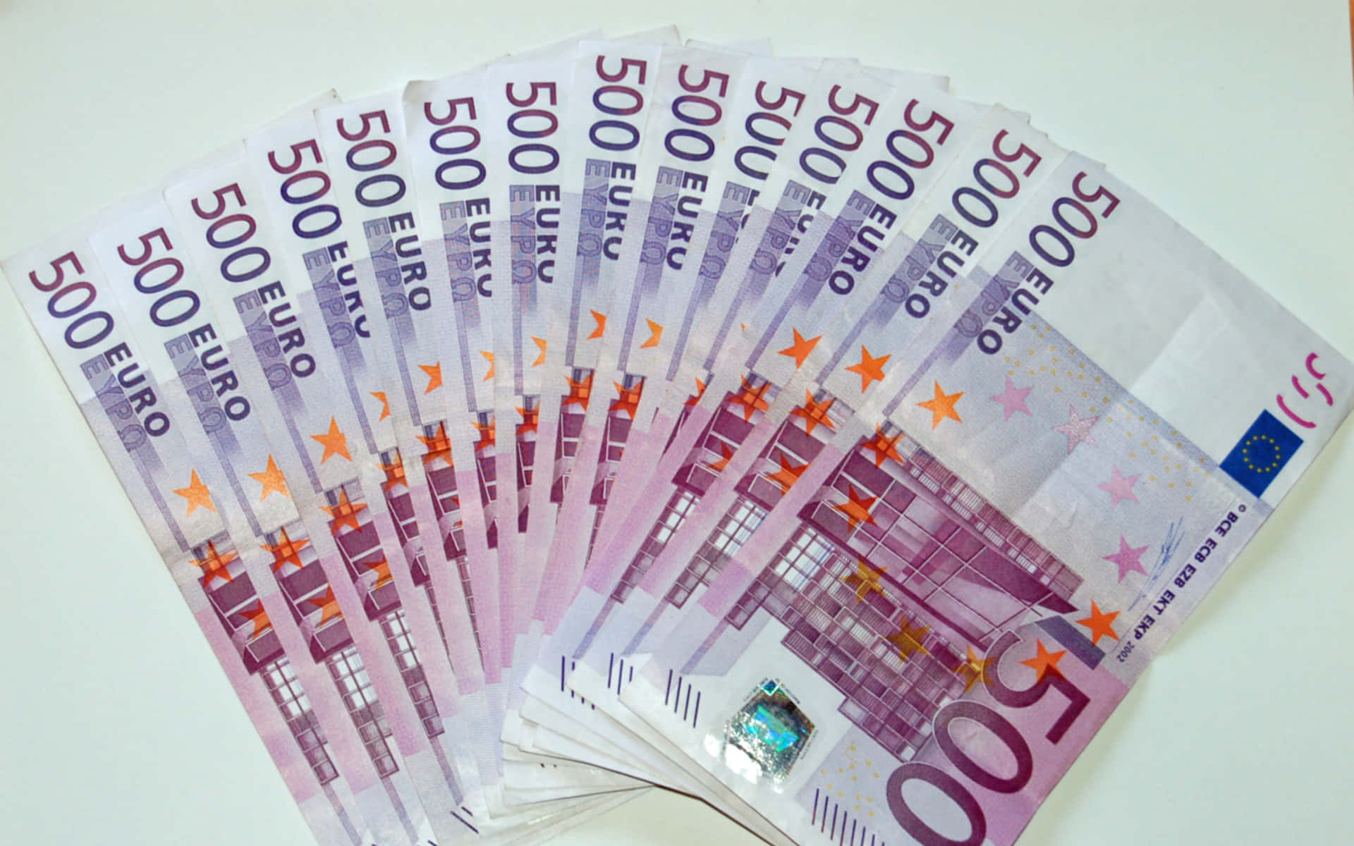 A Stack Of Euro Banknotes On A White Table
