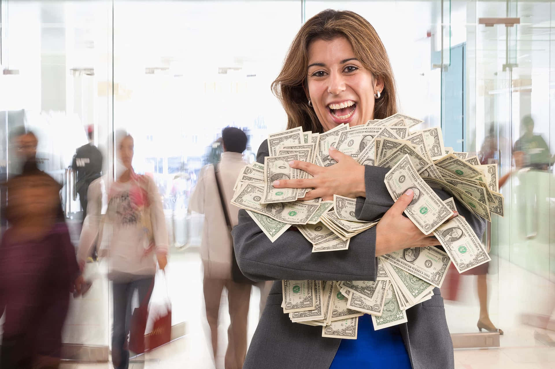 A Woman Holding A Bunch Of Money In Her Hands