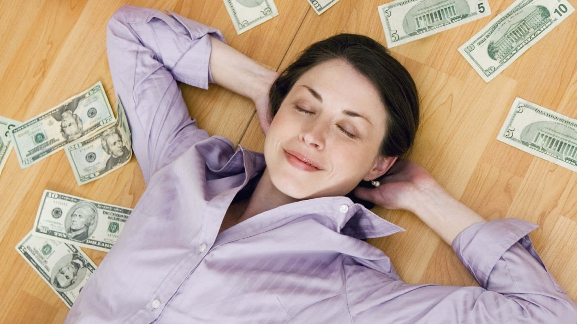 A Woman Lying On The Floor With Money On Her Head