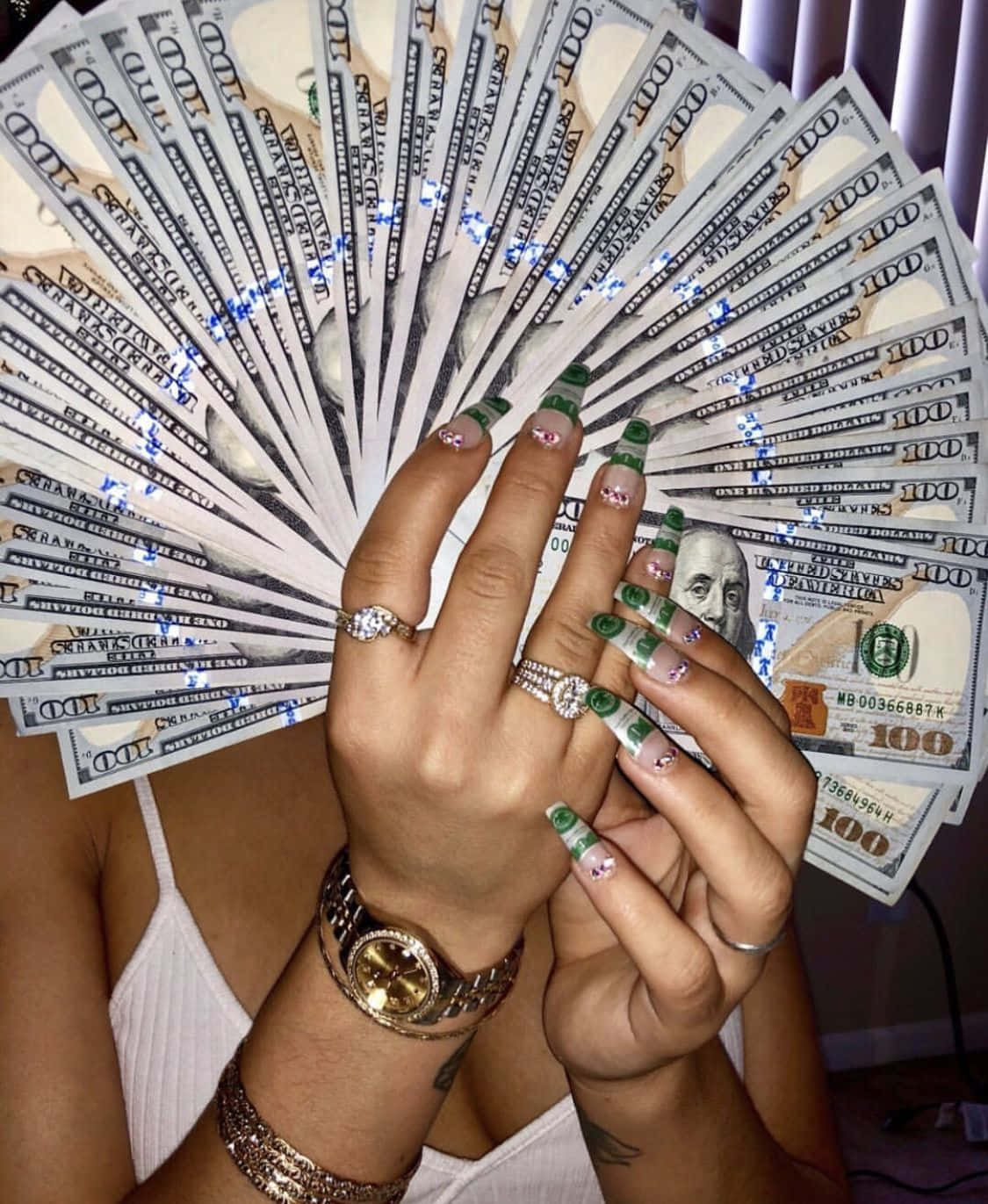 A Woman Holding Up A Fan With Money In It