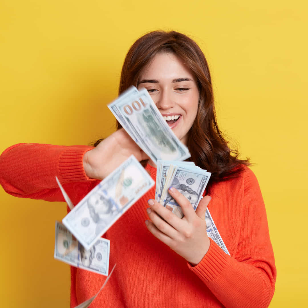 Woman Holding Money In Her Hands And Smiling