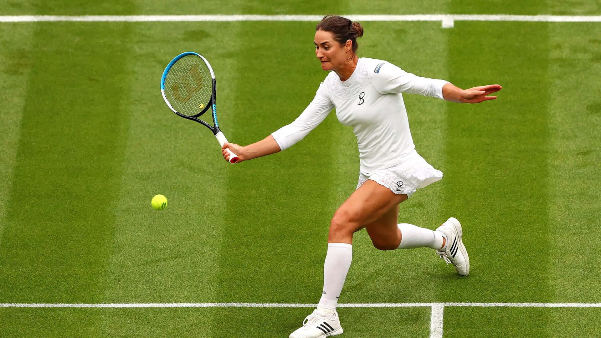 Monica Niculescu in action, wearing a white tennis outfit. Wallpaper
