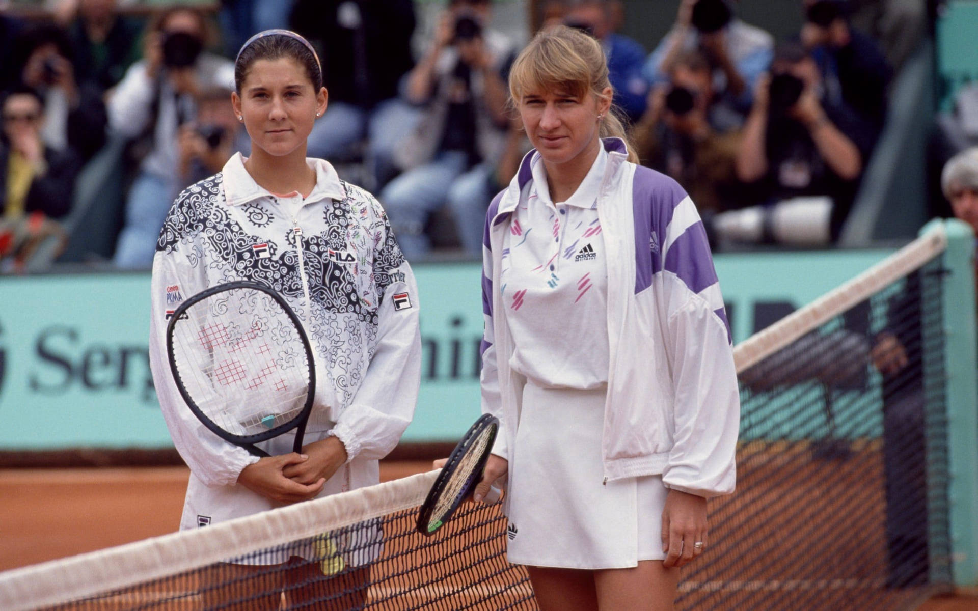 'Monica Seles and Steffi Graf during a vintage tennis match' Wallpaper