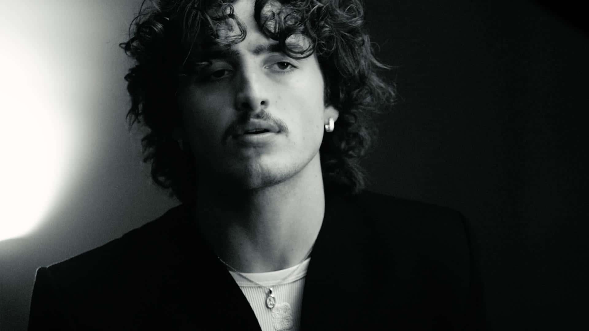 Monochrome_ Portrait_of_ Curly_ Haired_ Man Wallpaper