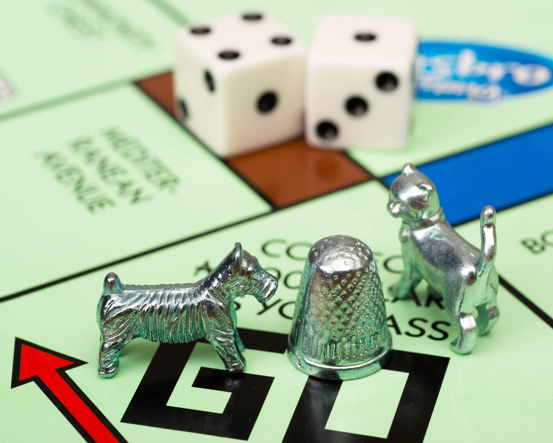Iconic Silver Game Pieces of Monopoly Board Game Wallpaper