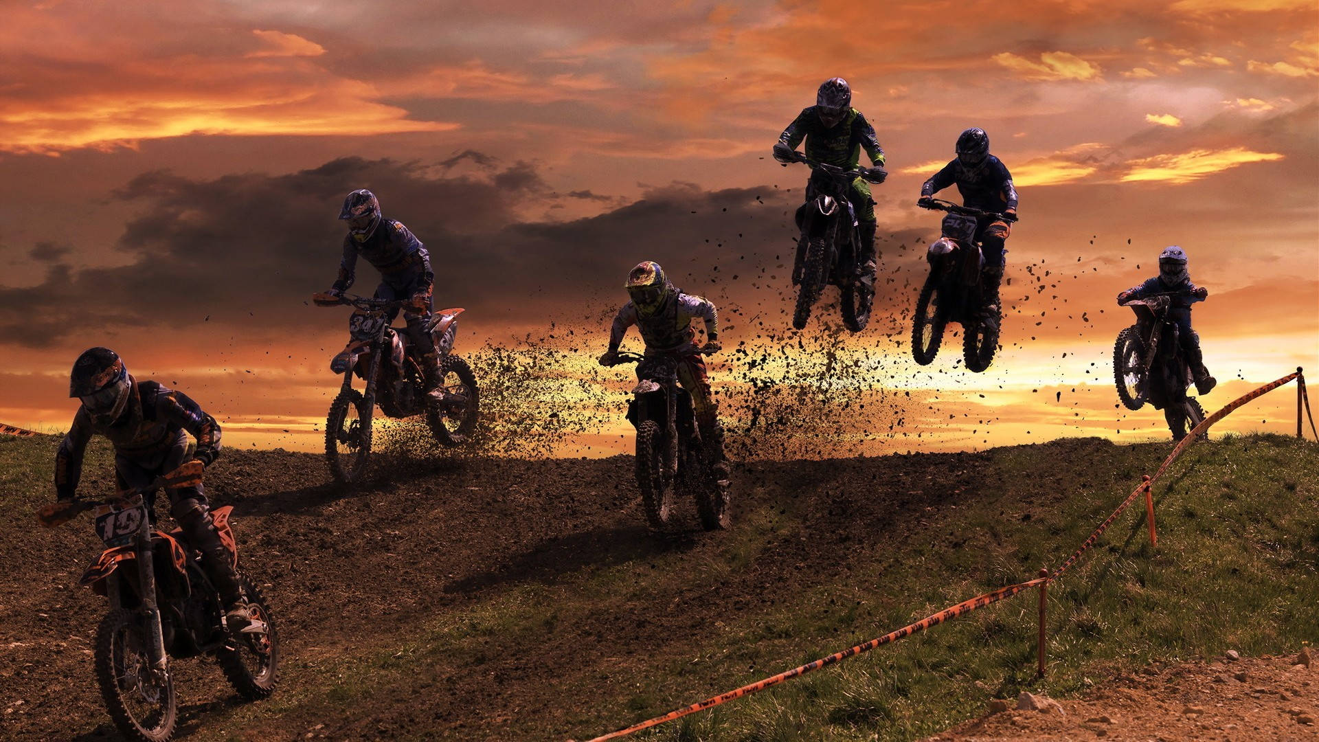 A Group Of People Riding Dirt Bikes Wallpaper
