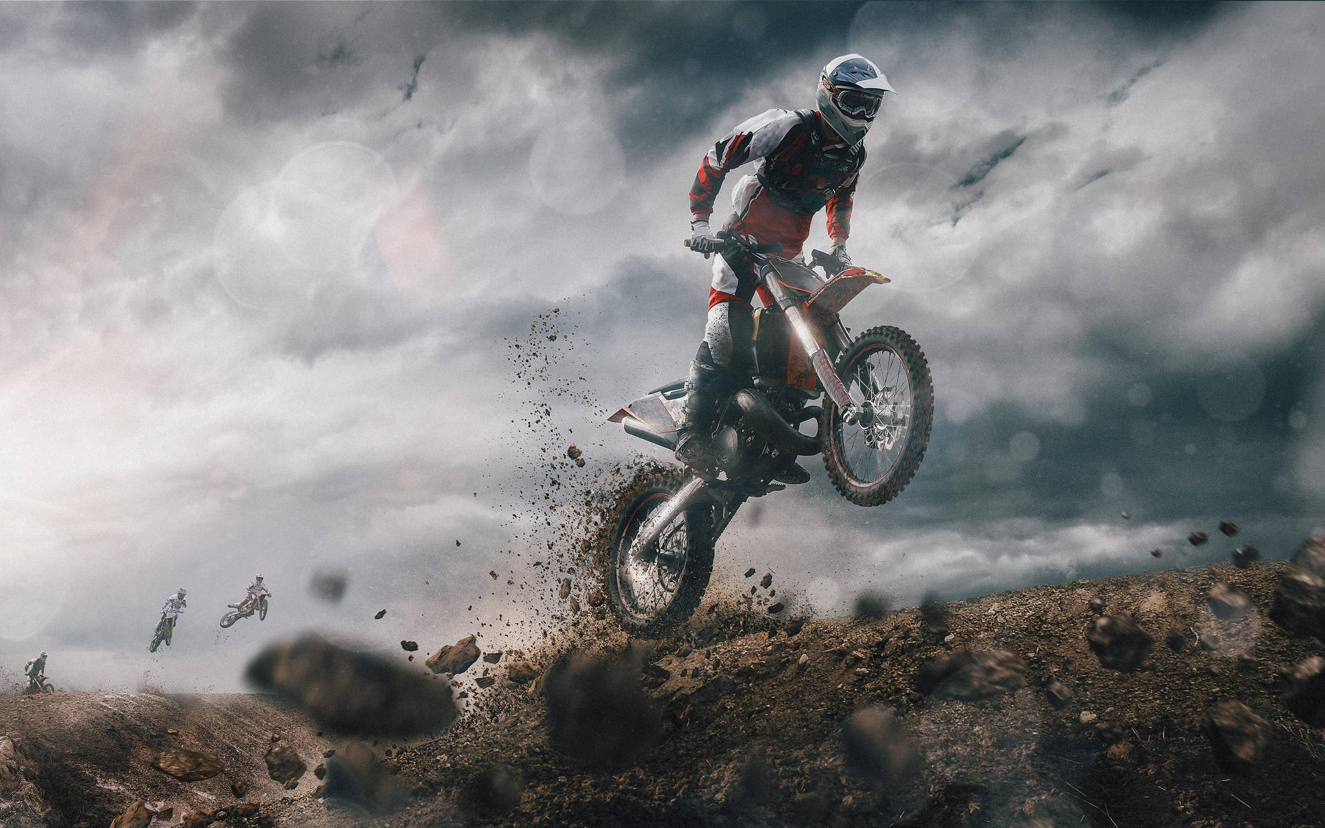 A Dirt Bike Rider Is Jumping Over A Dirt Field Wallpaper