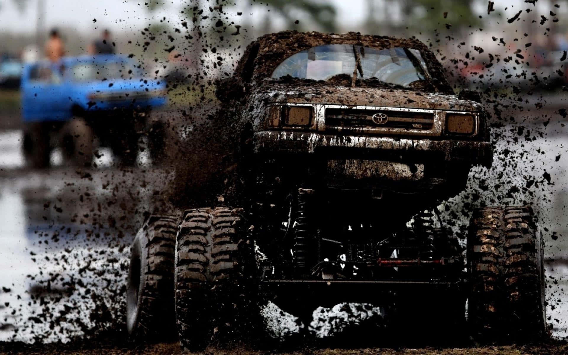 Thrilling adventure with a monster truck plowing through the mud Wallpaper