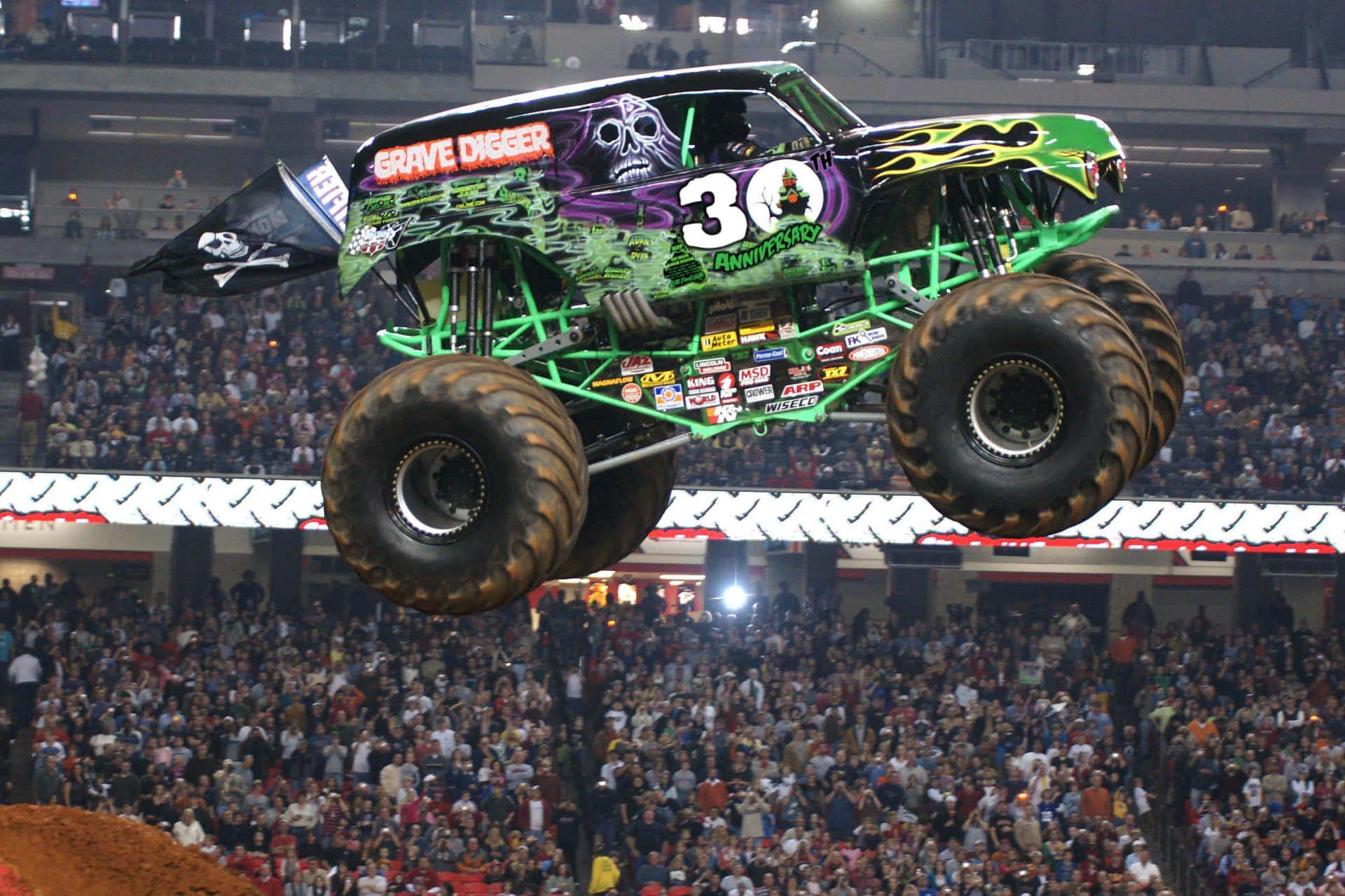 A Monster Truck In The Air Over A Crowd