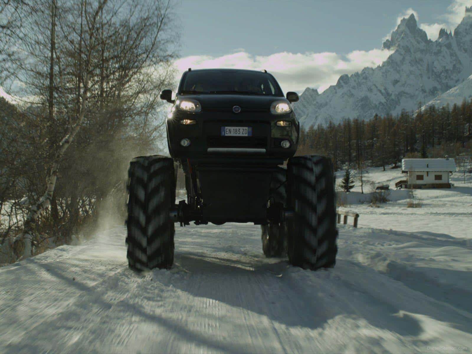 A Black Truck Driving Down A Snowy Road