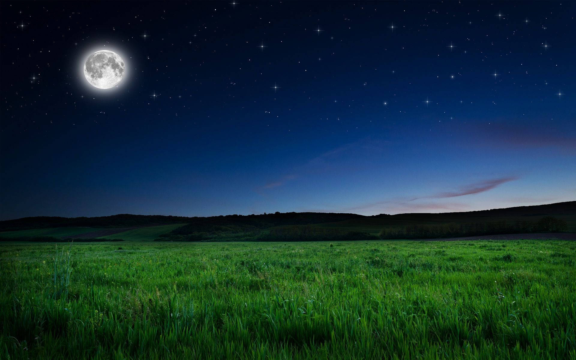 The moon lights up the night sky Wallpaper