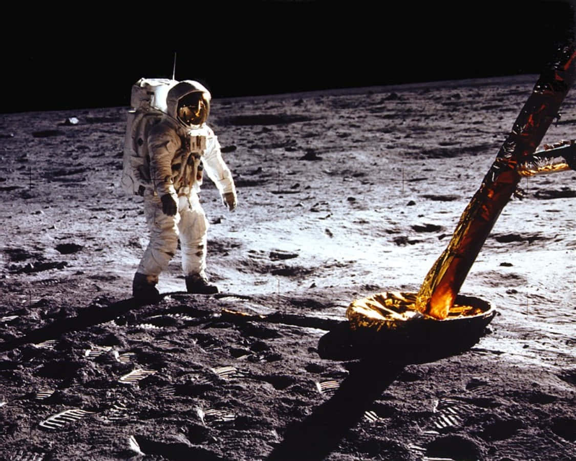 A Man In Spacesuit Standing On The Moon