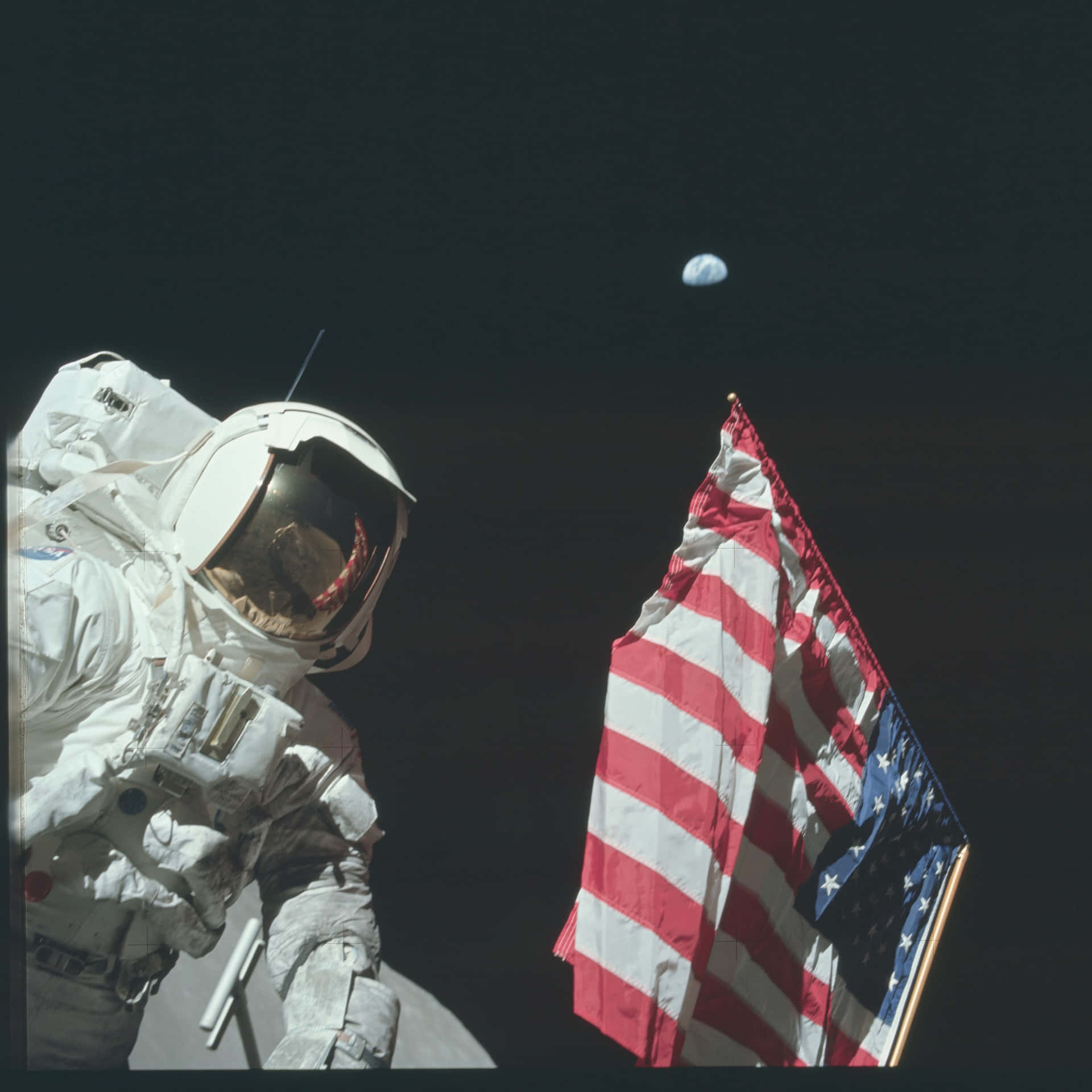 An Astronaut Is Standing Next To An American Flag