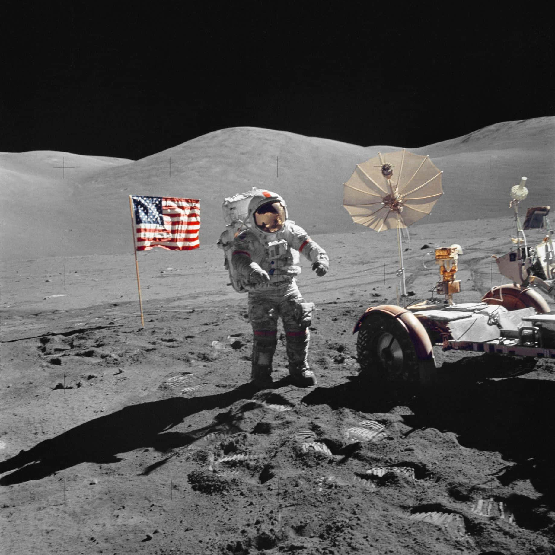 A Man Standing Next To A Rover On The Moon