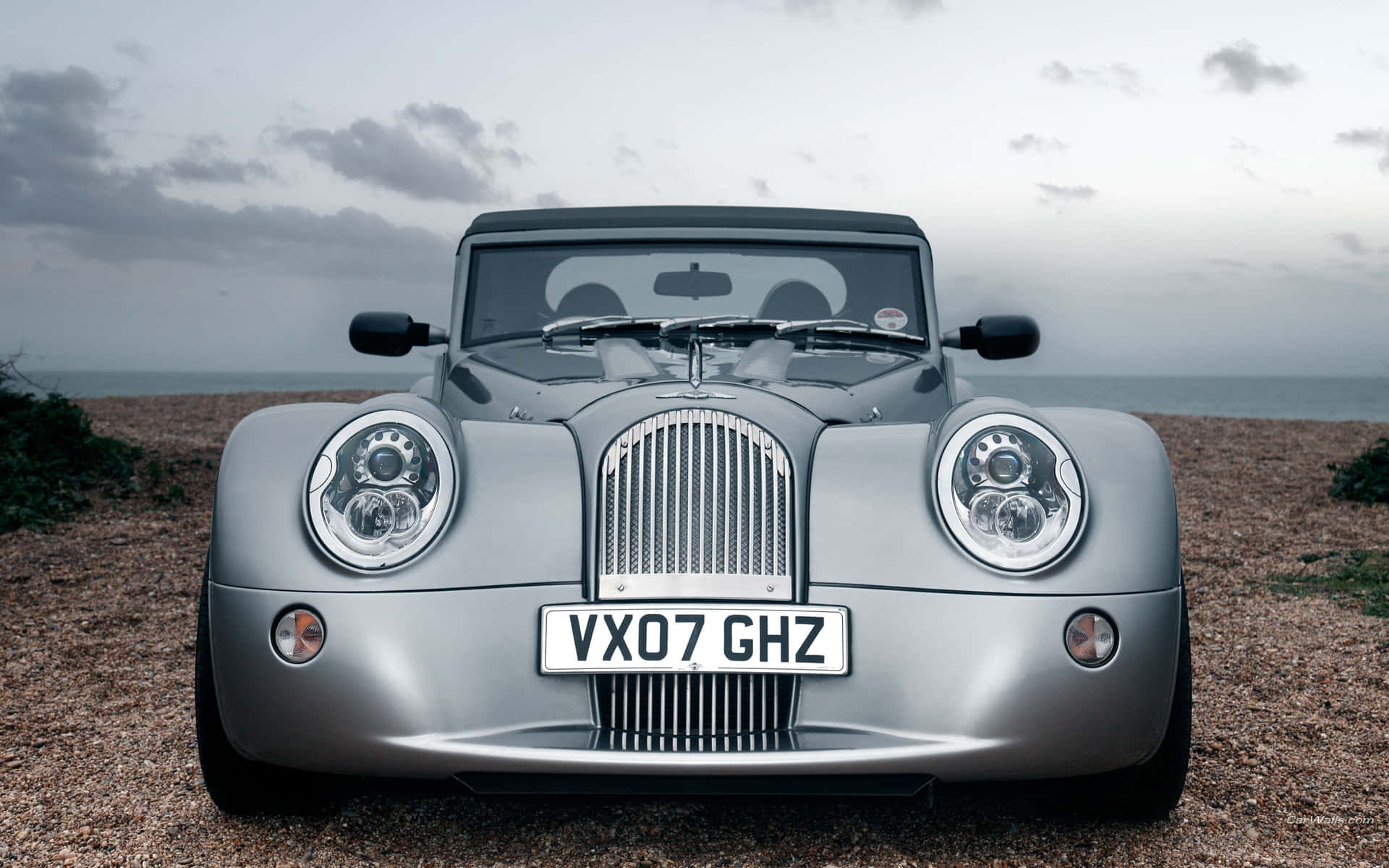 Beautiful Morgan sports car parked by the picturesque coast Wallpaper