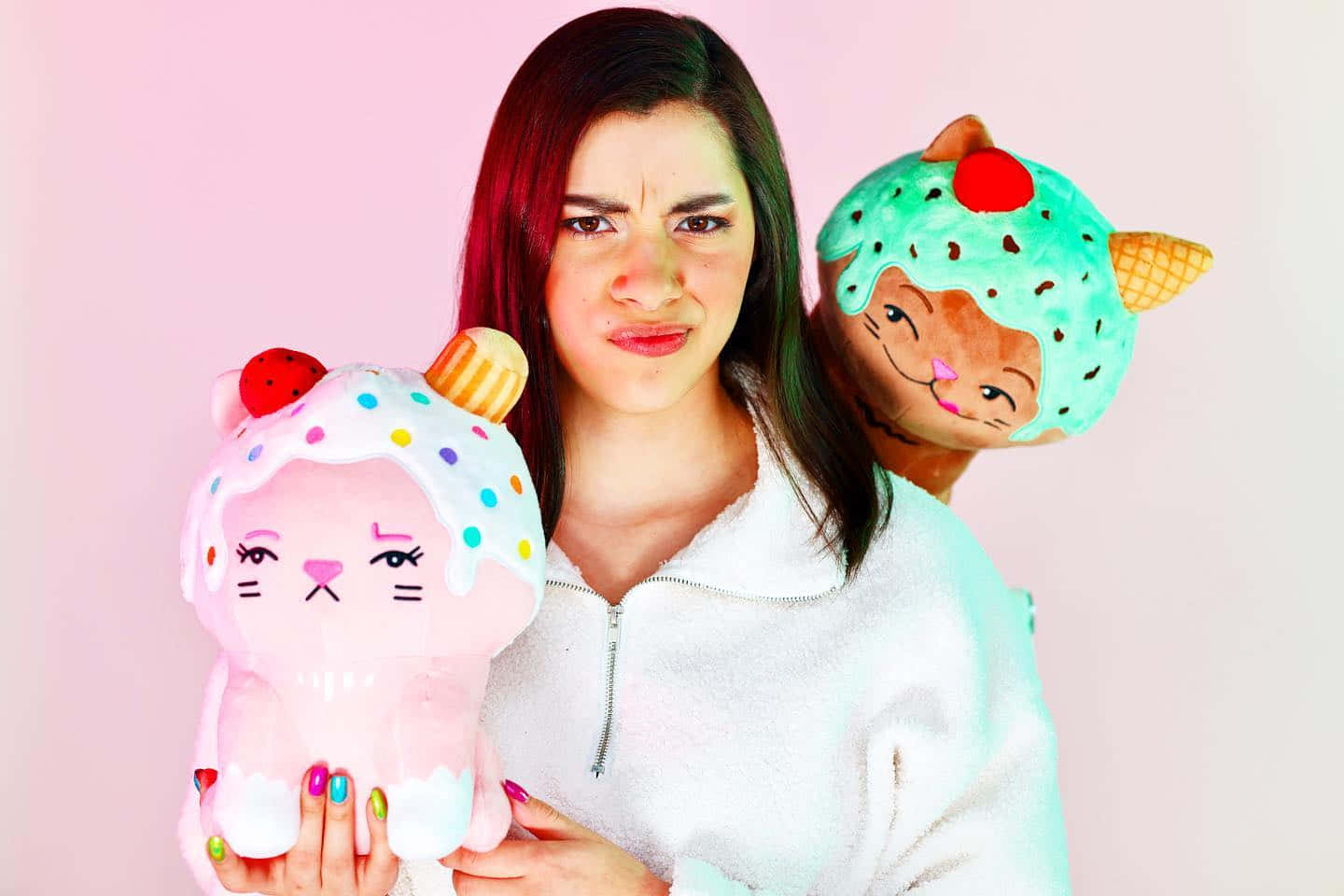 A Woman Holding Two Plush Stuffed Animals Wallpaper