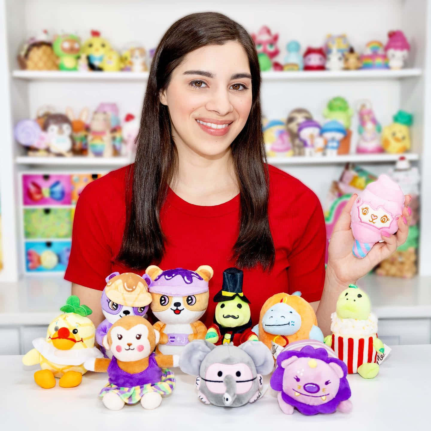 A Woman Is Holding A Bunch Of Stuffed Animals Wallpaper