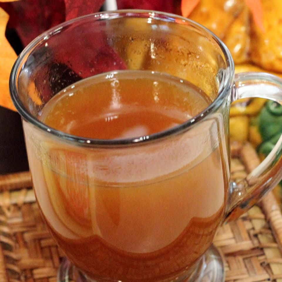 A Cup Of Apple Cider With A Pumpkin On It