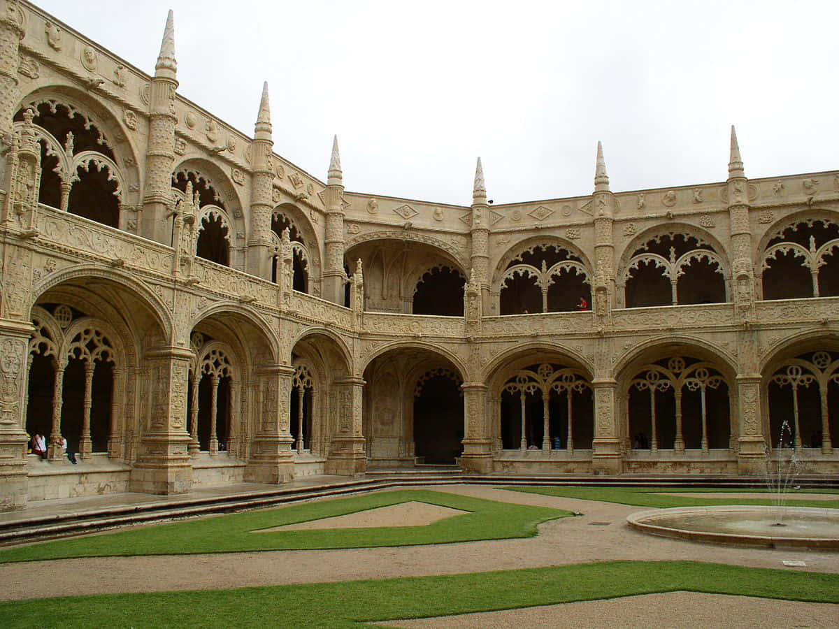 Stunning view of the Mosteiro dos Jeronimos Courtyard in Lisbon, Portugal Wallpaper