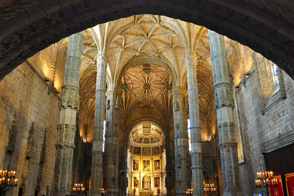Mosteiro Dos Jeronimos From An Archway Wallpaper