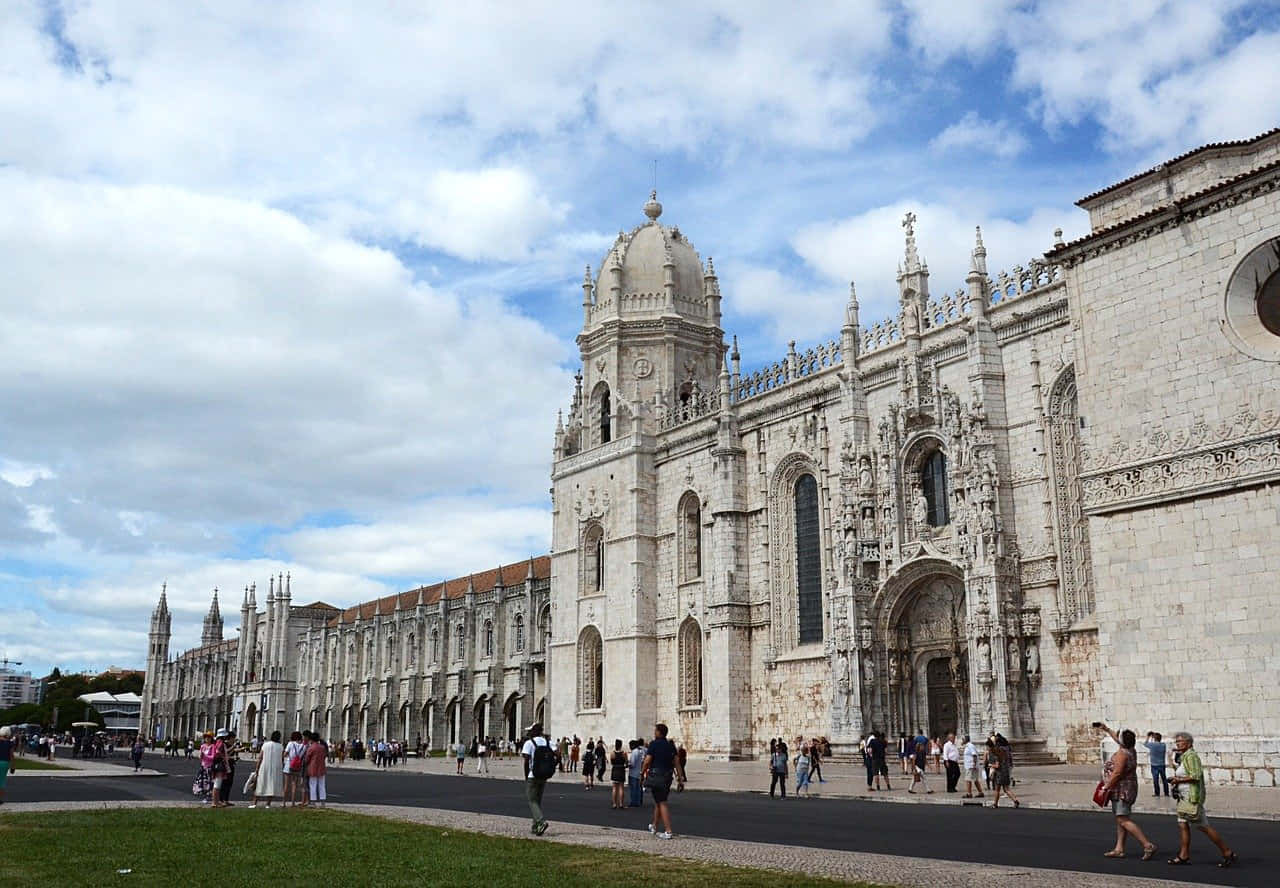 Majestic view of the front exterior of Mosteiro dos Jeronimos in Lisbon, Portugal. Wallpaper
