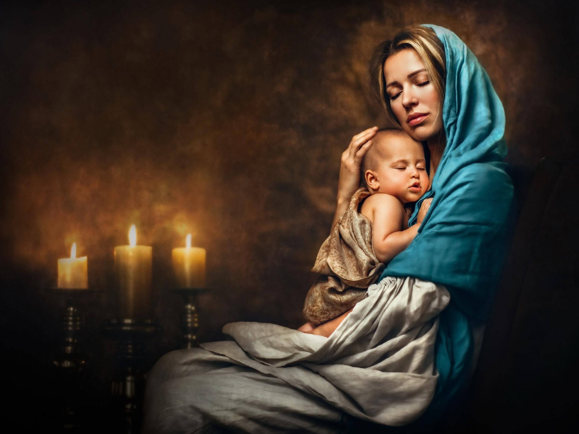 Mother And Baby With Candles Wallpaper