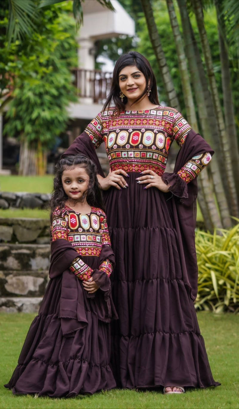 Mother And Daughter In Ethnic Garments Wallpaper