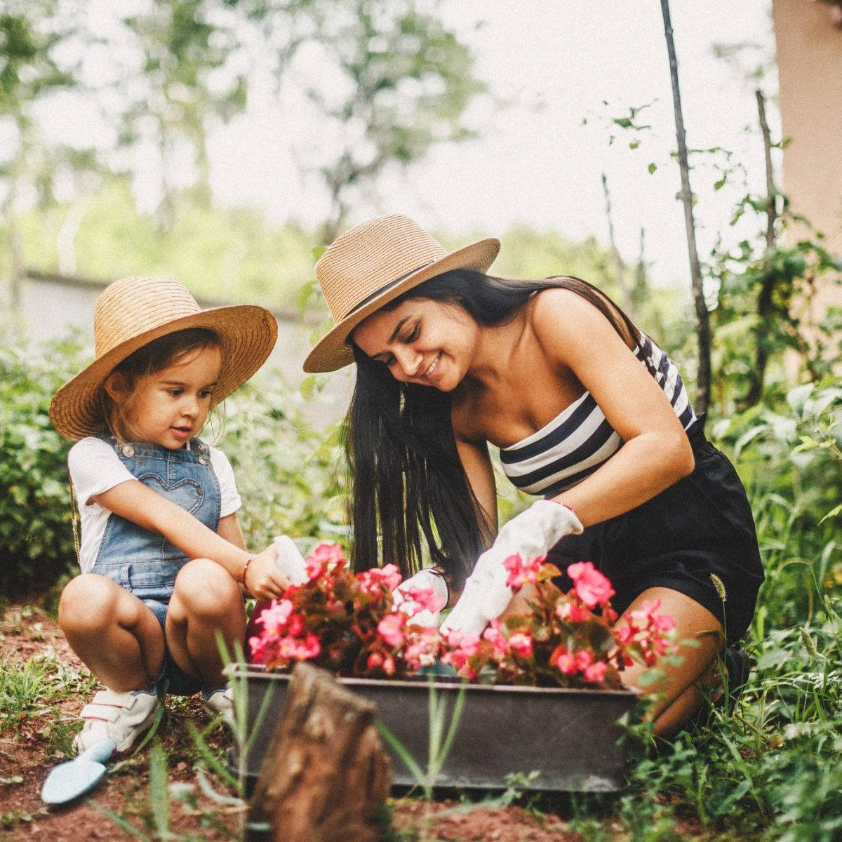 Mother And Daughter In Gardening Hat Wallpaper
