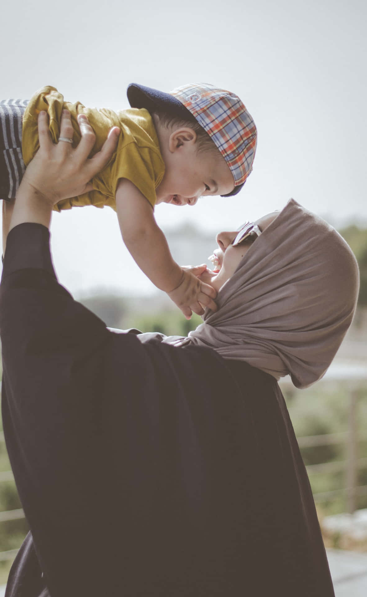 Mother Lifting Muslim Boy Wallpaper