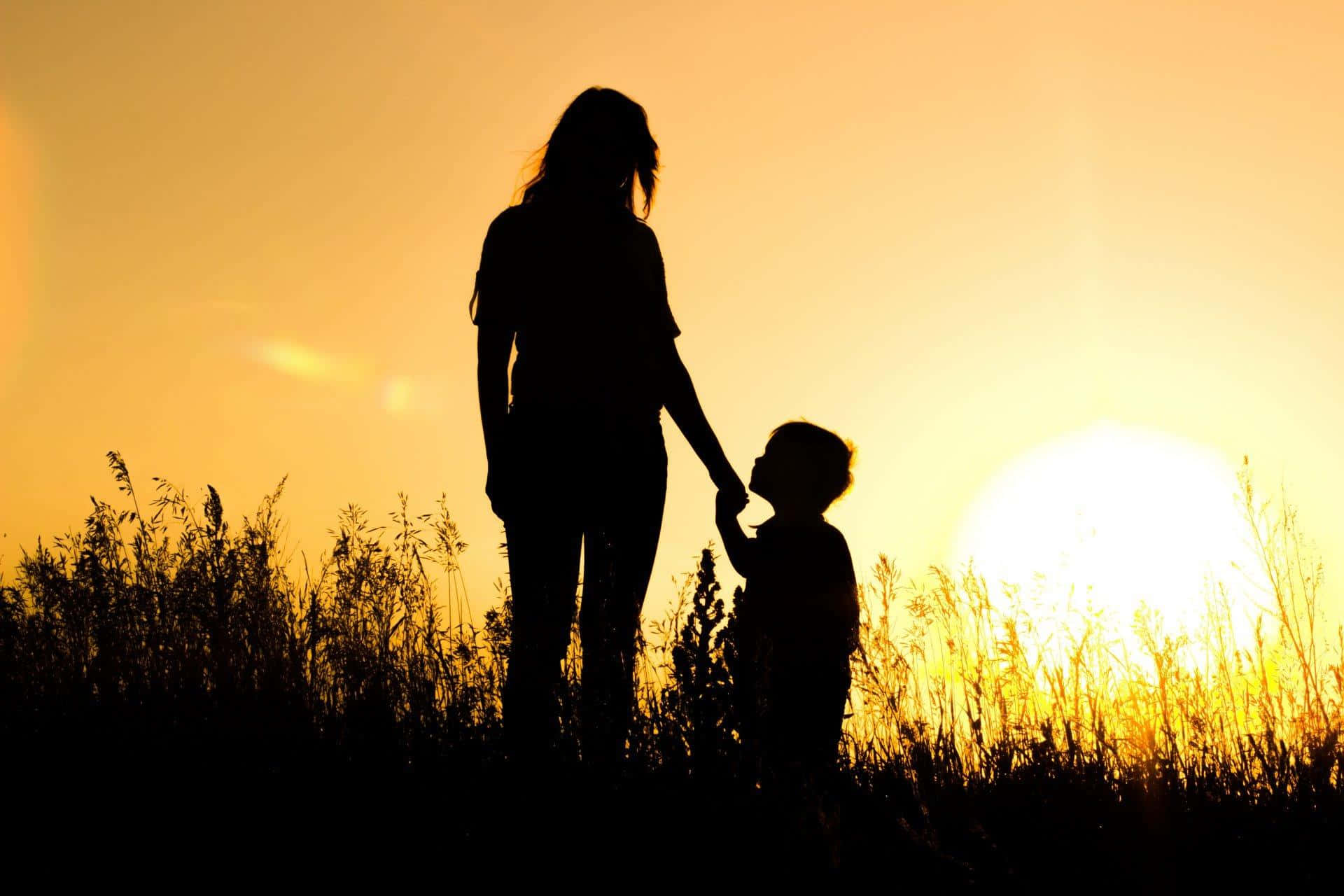 Mother And Baby Against Sunset Picture