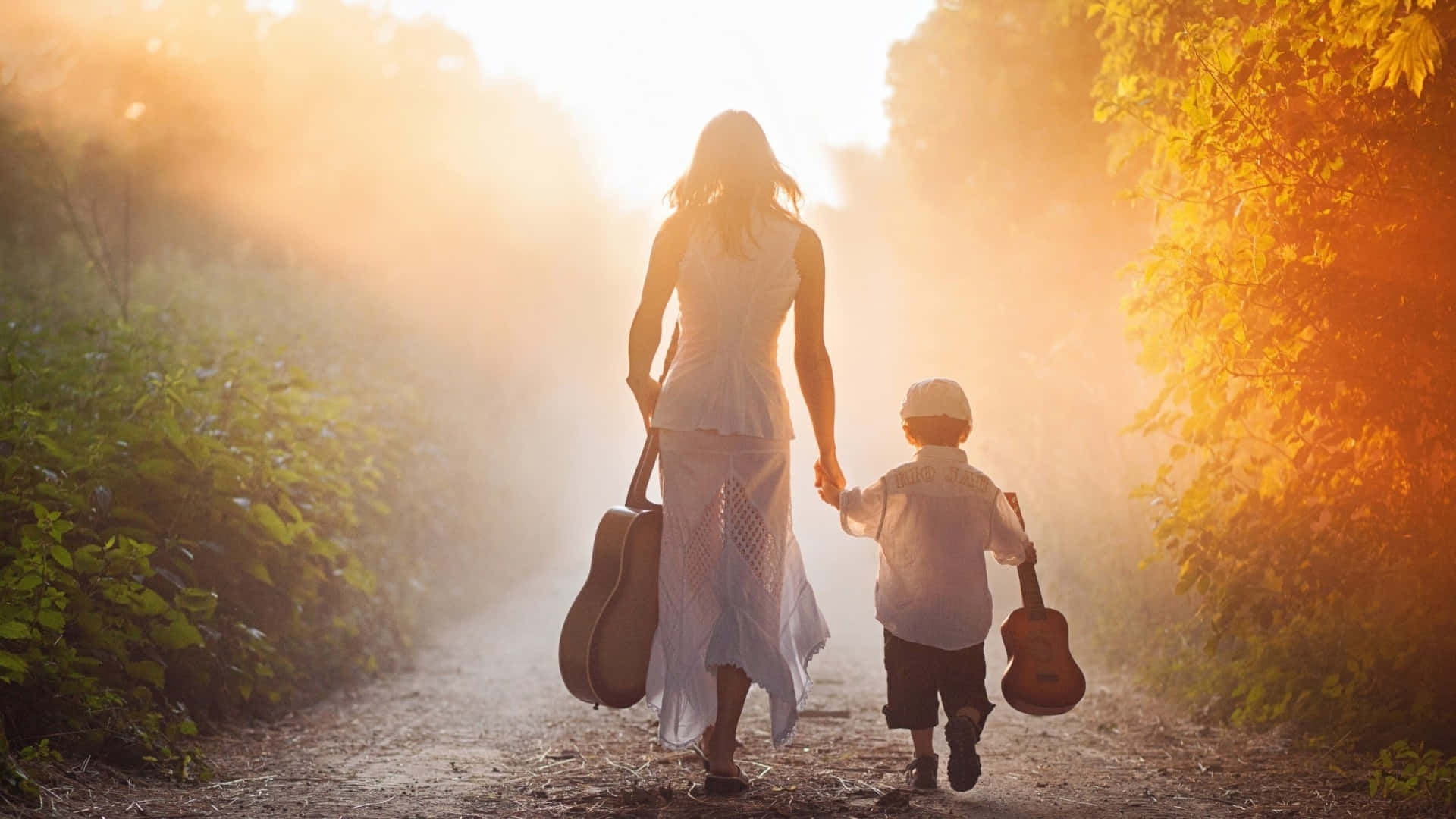Mother And Son Carrying Guitars Picture