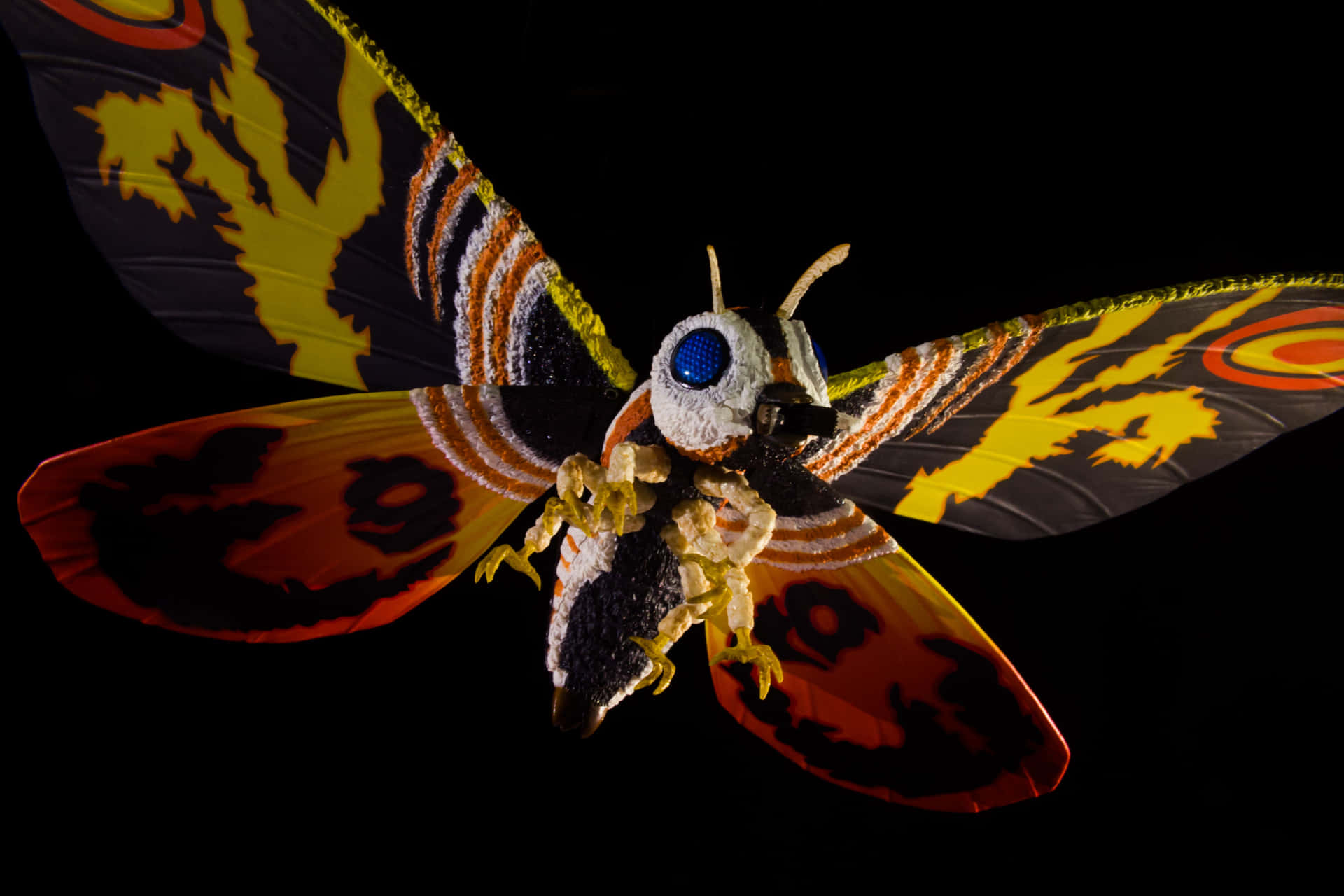 Majestic Mothra soaring through the night sky Wallpaper