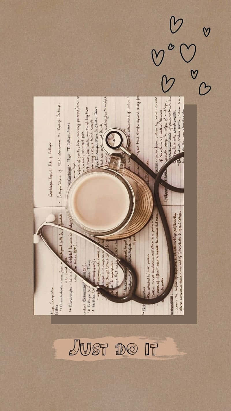 Motivational Nursing Aestheticwith Coffeeand Stethoscope Wallpaper