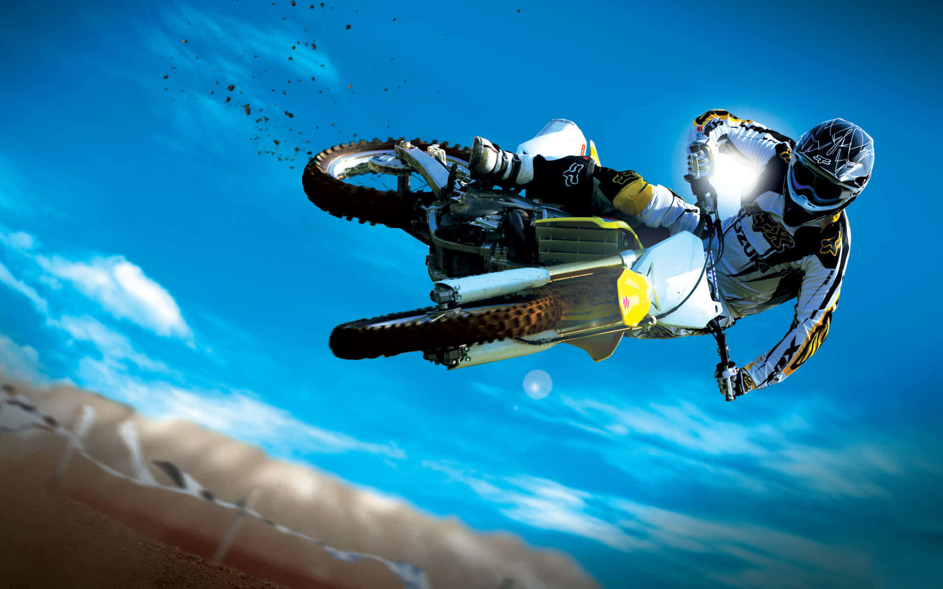 A fearless motocross rider soaring high mid-air in a thrilling jump