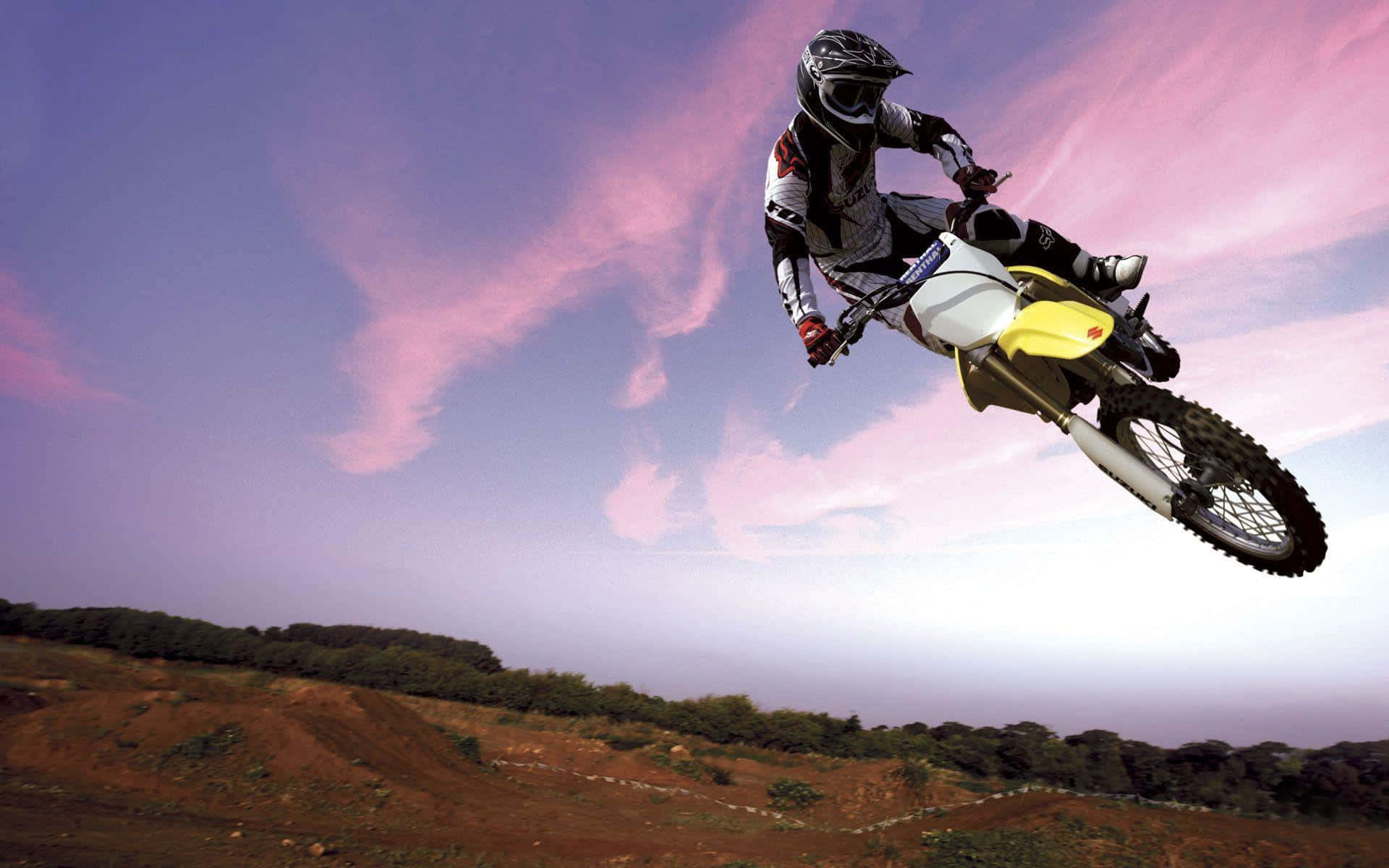 Motocross rider catching air on dirt track