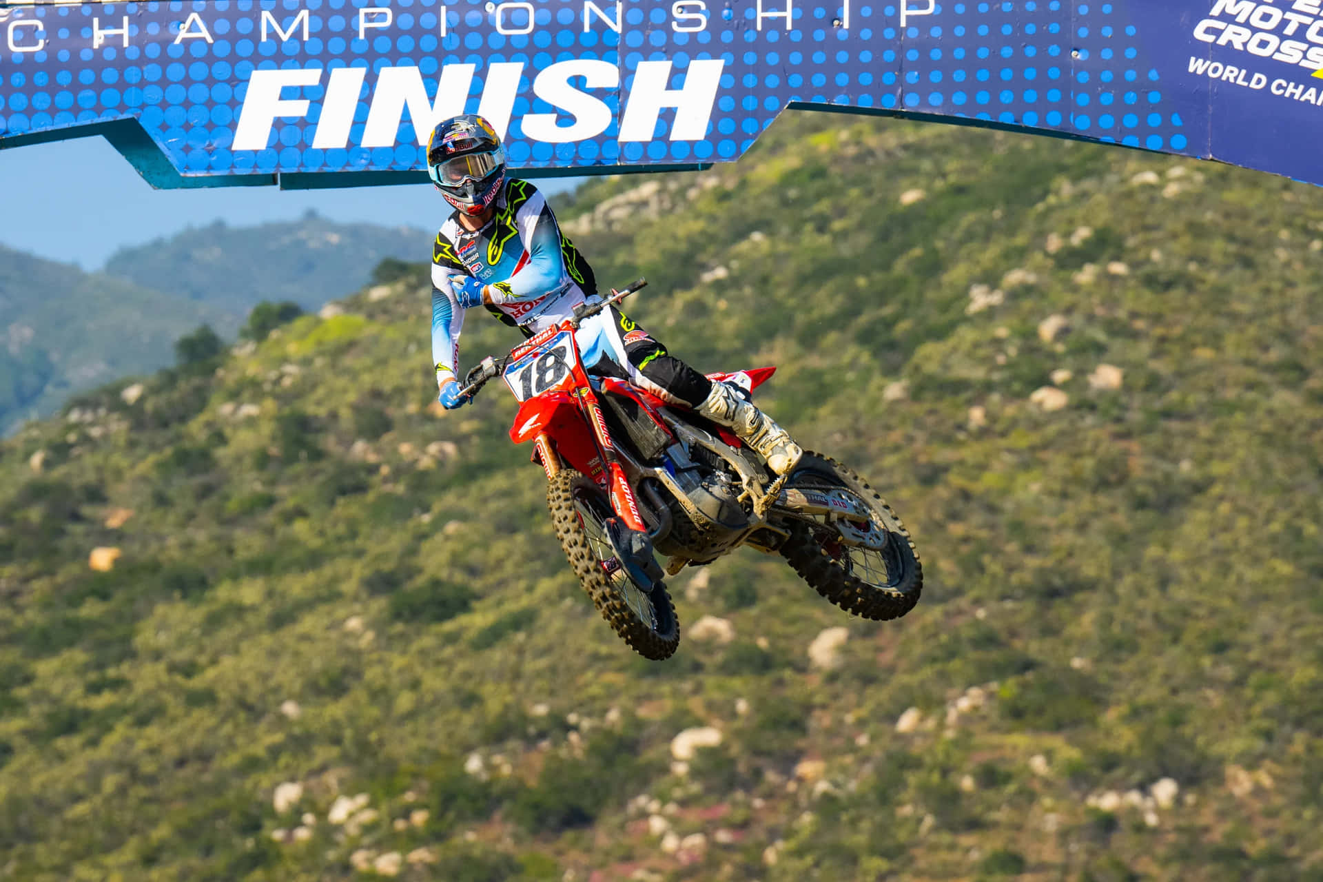 Download Motocross Racer Jumpsto Finish Line Wallpaper | Wallpapers.com