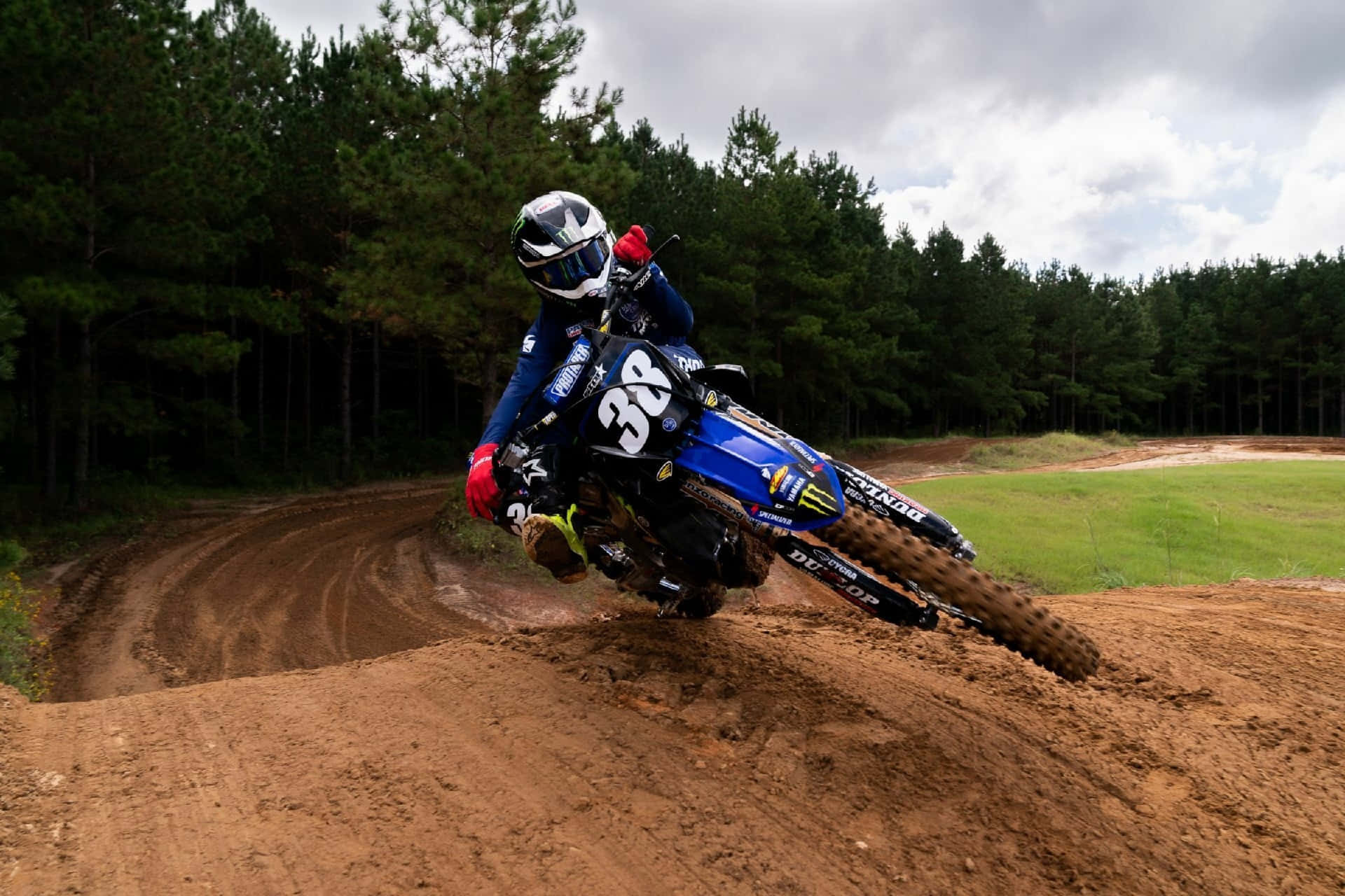 Motocross Rider Cornering Action Wallpaper