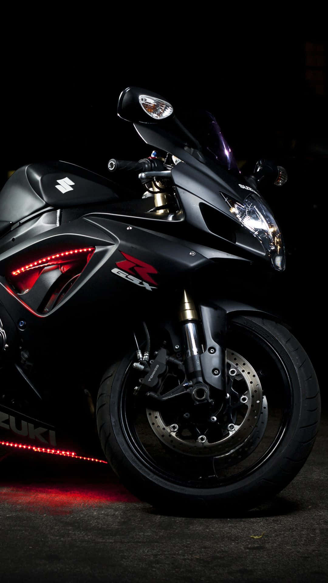 A Black Motorcycle Is Parked In A Dark Area Wallpaper